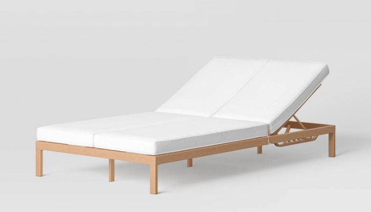 Double wide pool lounge chair with a wood frame and white cushion.