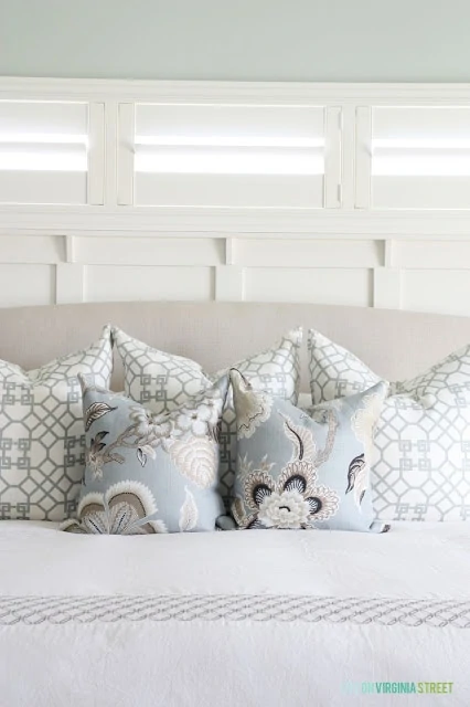 Soft blue floral pillow on the bed in the master bedroom.