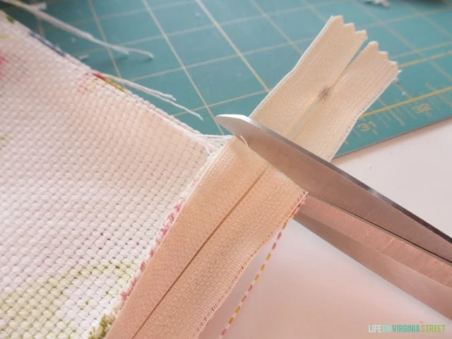 Cutting the excess zipper.