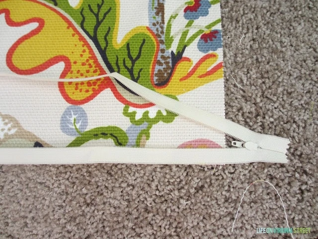 The zipper now out of its packaging on the rug.